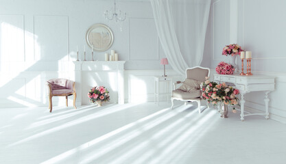 luxury clean bright white interior. a spacious room with sunlight and flowers in vases and royal chic furniture. 