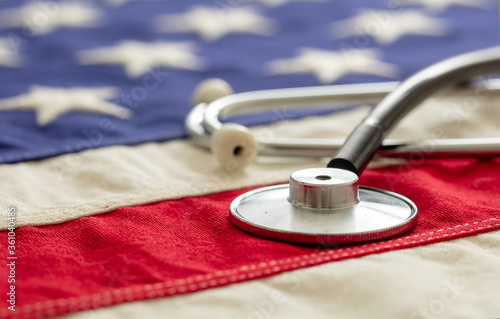 Fotomural US health. Medical stethoscope on a USA flag, closeup view.