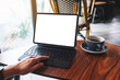 © Farknot Architect - Mockup image of a woman touching on tablet touchpad with blank white desktop screen as a computer pc with coffee cup on the table