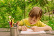 © zwiebackesser - Portrait of young beautiful girl drawing with colored pencils.