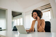 © bnenin - Beautiful businesswoman with headset and laptop at workplace, portrait.