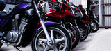 Colored sports, road beautiful bikes in a motor show, close up. Many motorcycles parked in a store. Sale of used cruise motorbikes in the cabin. Showroom equipment in the garage. Banner for web site