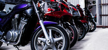 Colored Sports, Road Beautiful Bikes In A Motor Show, Close Up. Many Motorcycles Parked In A Store. Sale Of Used Cruise Motorbikes In The Cabin. Showroom Equipment In The Garage. Banner For Web Site