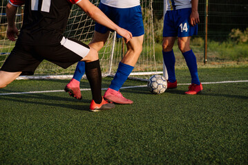 Soccer players play football on soccer field