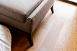 © whyframeshot - closeup of detail leather sofa color tone with wooden floor background