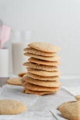 Canvas Print - Vertical shot of a stack of homemade cookies with white napkins on a tray