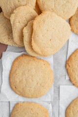 Canvas Print - Vertical shot of a stack of homemade cookies with white napkins on a tray