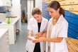 © makasana photo - Pharmacist consults with her assistant about a medical prescription