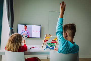 Wall Mural - kids learning at home, boy and girl doing online math lesson