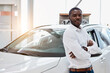 © alfa27 - portrait of happy handsome african man in car dealership, afro man came to buy beautiful luxurious auto. successful purchase in cars showroom