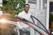 © alfa27 - portrait of happy handsome african man in car dealership, afro man came to buy beautiful luxurious auto. successful purchase in cars showroom