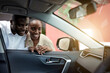© alfa27 - black african couple liked a car in dealership, they want to buy it, discuss together