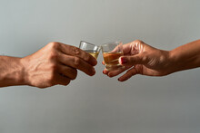 Hands With Shot Glasses Toasting. Concept Of Alcoholism And Addiction.