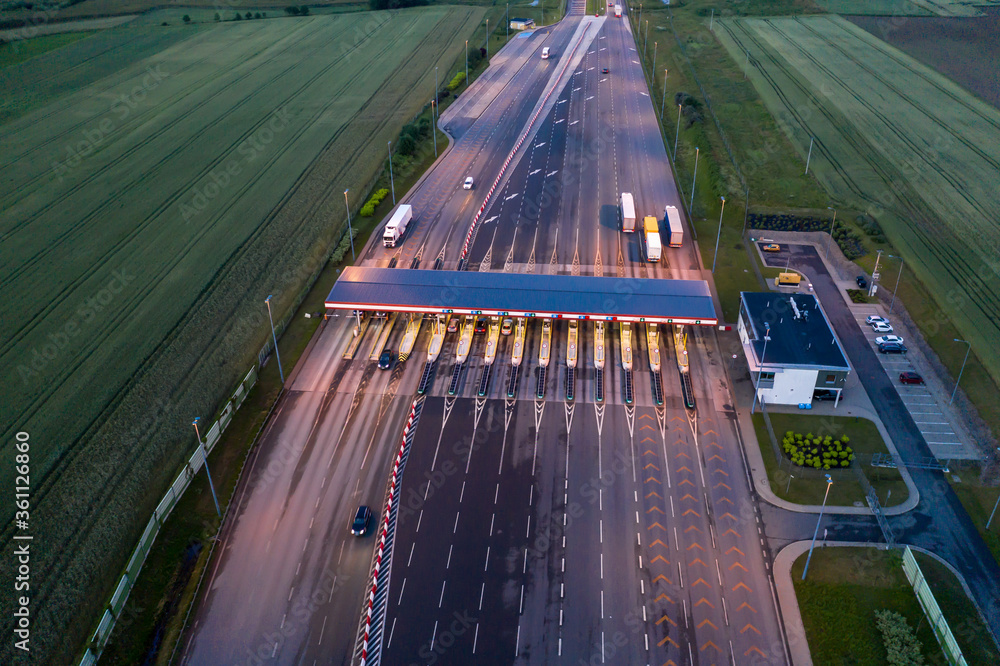 Obraz na płótnie Car traffic transportation on multiple lanes highway road and toll collection gate, drone aerial top view at Night. Commuter transport, city life concept.A2 Poland Lodz w salonie