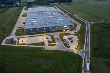 Sticker - Aerial top down view of the large logistics park with warehouse at Night, loading hub with semi trucks with cargo trailers standing at the ramps for load/unload goods
