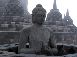 Wall Mural - Shallow focus closeup shot of the statue of Buddha in Borobudur Temple, Mungkid, Indonesia