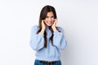 © luismolinero - Teenager girl over isolated white background frustrated and covering ears