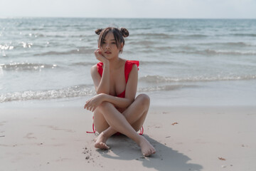 Young sexy woman in bikini enjoying summer vacation on beach relaxing holiday