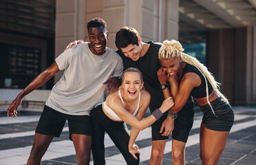 Wall Mural - Group of runners having fun after outdoor training