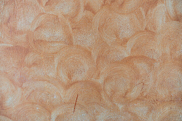 Background close-up of the swirl texture details of the orange dirty grunge and vintage loft concrete with  copy space.