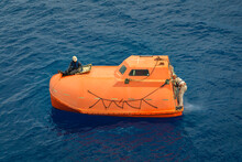 Freefall Lifeboat In The Water With Two Seamen Onboard 