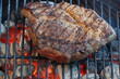 © Aaron J Hill - Beef chuck steak being cooked on a charcoal grill