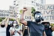 © Alessandro Biascioli - Activist wearing gas mask protesting against racism and fighting for equality - Black lives matter demonstration on street for justice and equal rights - Blm international movement concept