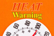 © Karen Roach - Heat Warning word message with closeup of a thermometer at 100 degrees
