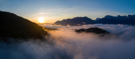 Wall Mural - aerial sunrise above cloud inversion in the mountains