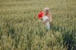 © Олег Кошевський - beautiful little girl with blond hair in a white dress in the background of a beautiful field. Girl with a bouquet of red poppies