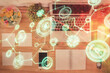 © peshkova - Social network hologram drawings over computer on the desktop background. Top view. Double exposure.
