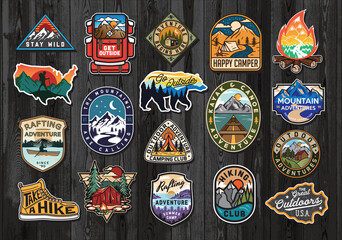 set of vintage outdoor summer camp logo patches on wood board. hand drawn and vector emblem designs.