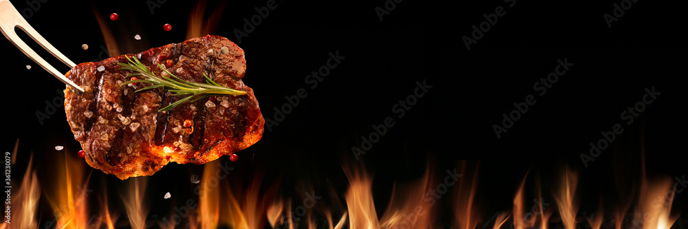 Beef steak falling on the grill with fire. Brazilian barbecue - obrazy, fototapety, plakaty 