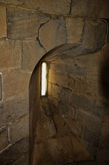 Canvas Print - Vertical shot of the window of an ancient castle In Loule