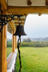 Sticker - Vertical shot of a metal bell on the building in the rural area