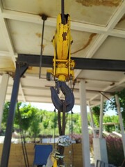 Canvas Print - Low angle shot of a yellow crane hook