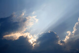 Fototapeta Na sufit - The rays of the sun through the clouds. Cloudscape Background Backdrop