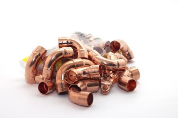 Sticker - Closeup shot of the curved copper fittings for plumbing isolated on white background