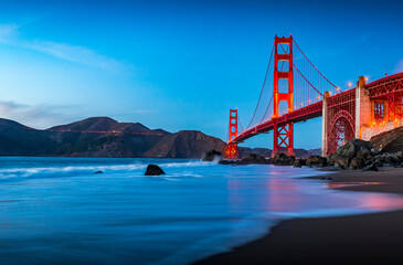 Wall Mural - Golden Gate Bridge view from the hidden and secluded rocky Marshall's Beach at sunset in San Francisco, California