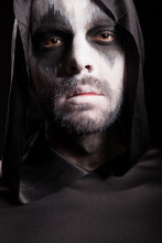 Close Up Portrait Of Grim Reaper Isolated Over Black Background. Halloween Costume.