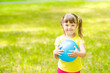 © Ermolaev Alexandr - Happy little girl with syndrome down holds ball in a summer park. Empty space for text