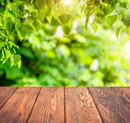 Wooden table and blurred green natural background.
