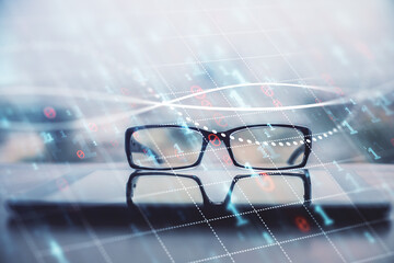 Financial graph hologram with glasses on the table background. Concept of business. Double exposure.