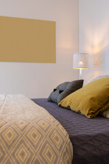 Wall Mural - Detail of bed with many colored cushions. A cozy and warm bedroom.