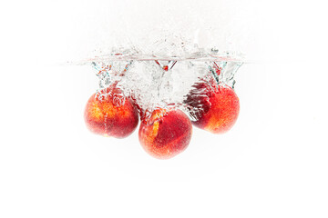 Wall Mural - Fresh Nectarines with water splash against white background