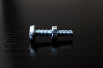 Bolt and nut on a wooden background