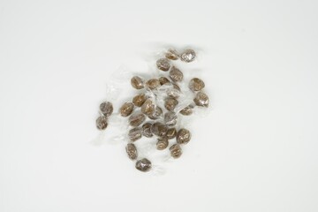 Poster - Small chocolate candies wrapped in plastic on the white background