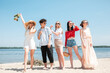 © master1305 - Picnic on the beach. Young, shiny. Seasonal feast at beach resort. Group of friends celebrating, resting, having fun in sunny summer day. Look happy, cheerful. Festive time, wellness, holiday, party.