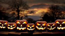 Seven Spooky Halloween Pumpkin, Jack O Lantern, With An Evil Face And Eyes On A Wooden Bench, Table With A Sunset, Night Background.