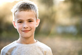 Portrait of a child boy outdoors on a warm sunny summer day.